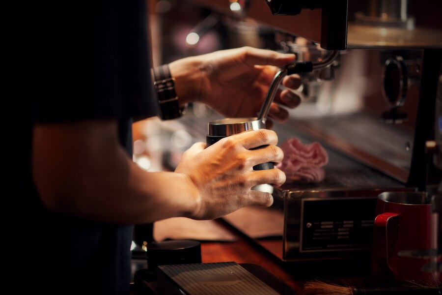 a person holding a cup with a metal handle