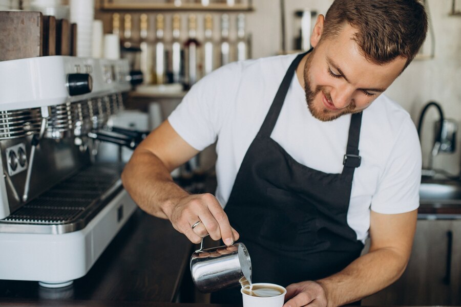 a person pouring a drink into a cup